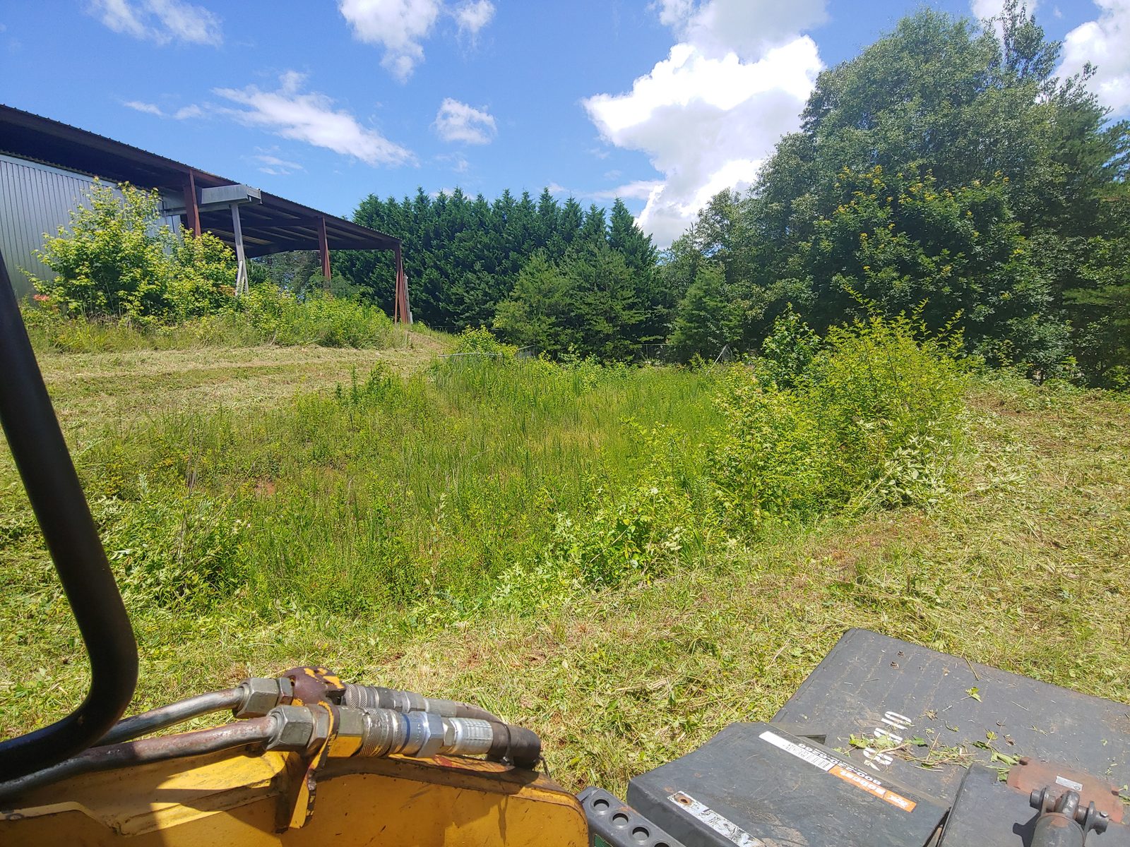 Bush hogging an overgrown field in Easley, SC